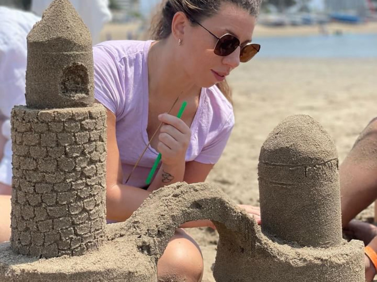 a man and a woman standing in front of a rock