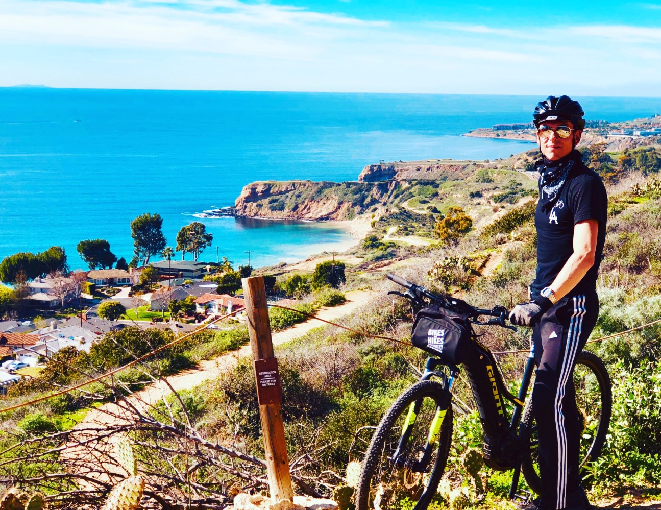 a man with a bicycle next to a body of water