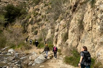 a group of people standing on a rocky path
