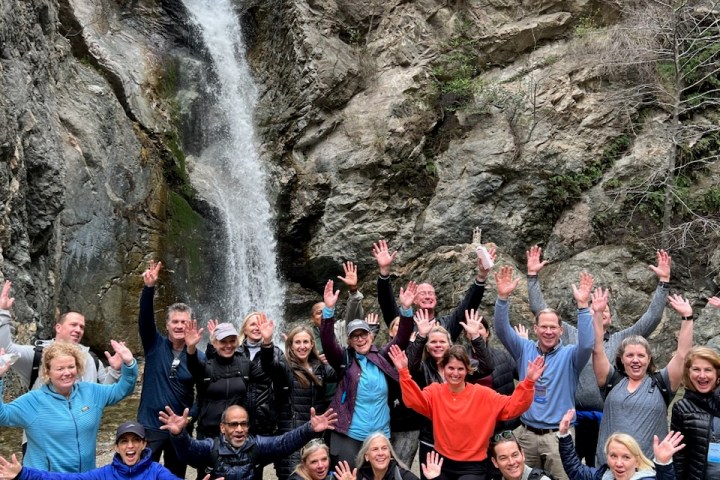 a group of people standing in front of a crowd posing for the camera