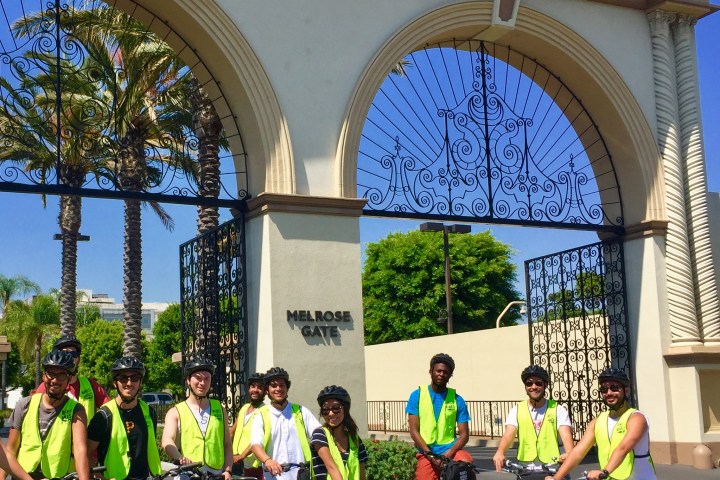 a group of people riding on the back of a bicycle
