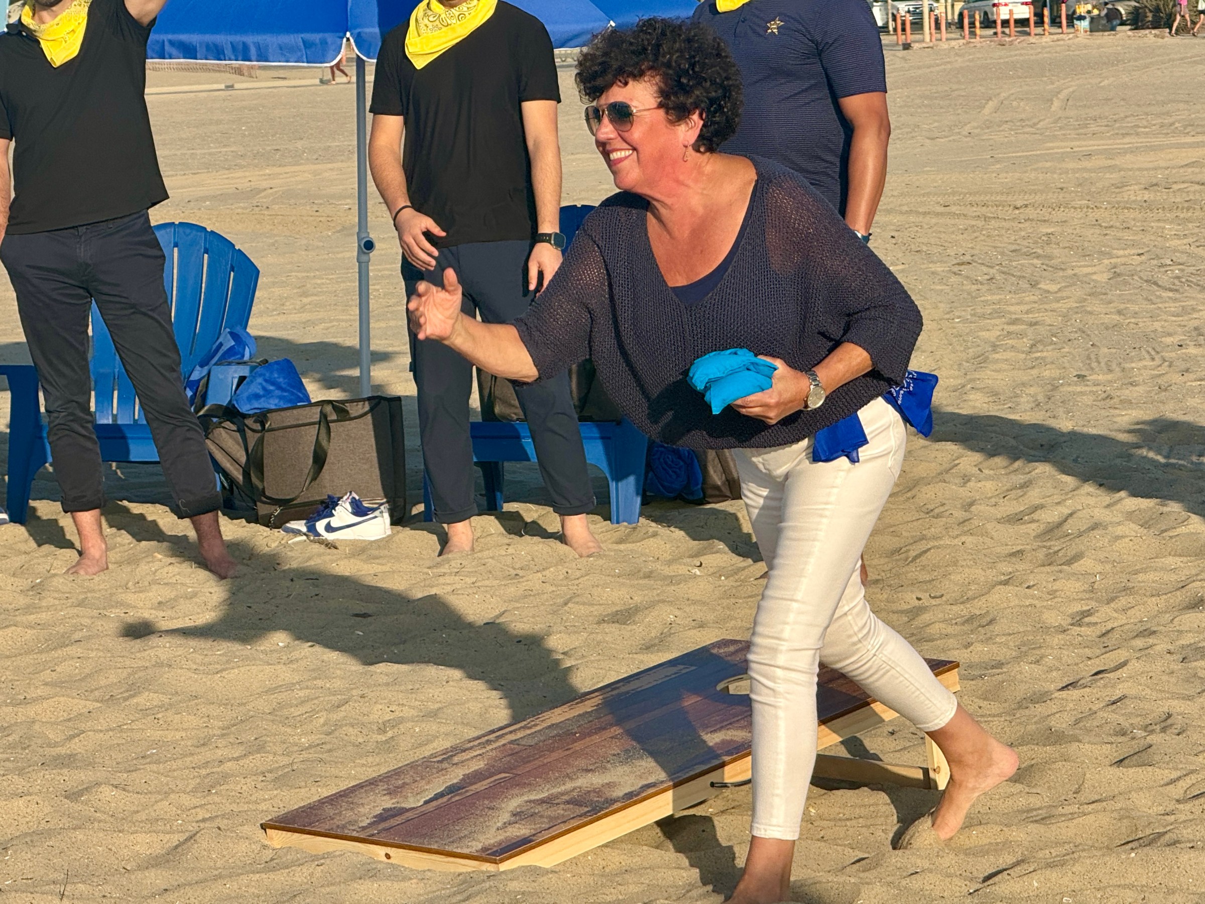 a group of people standing in the sand