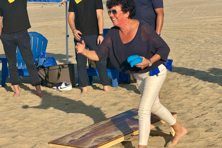 a group of people standing in the sand