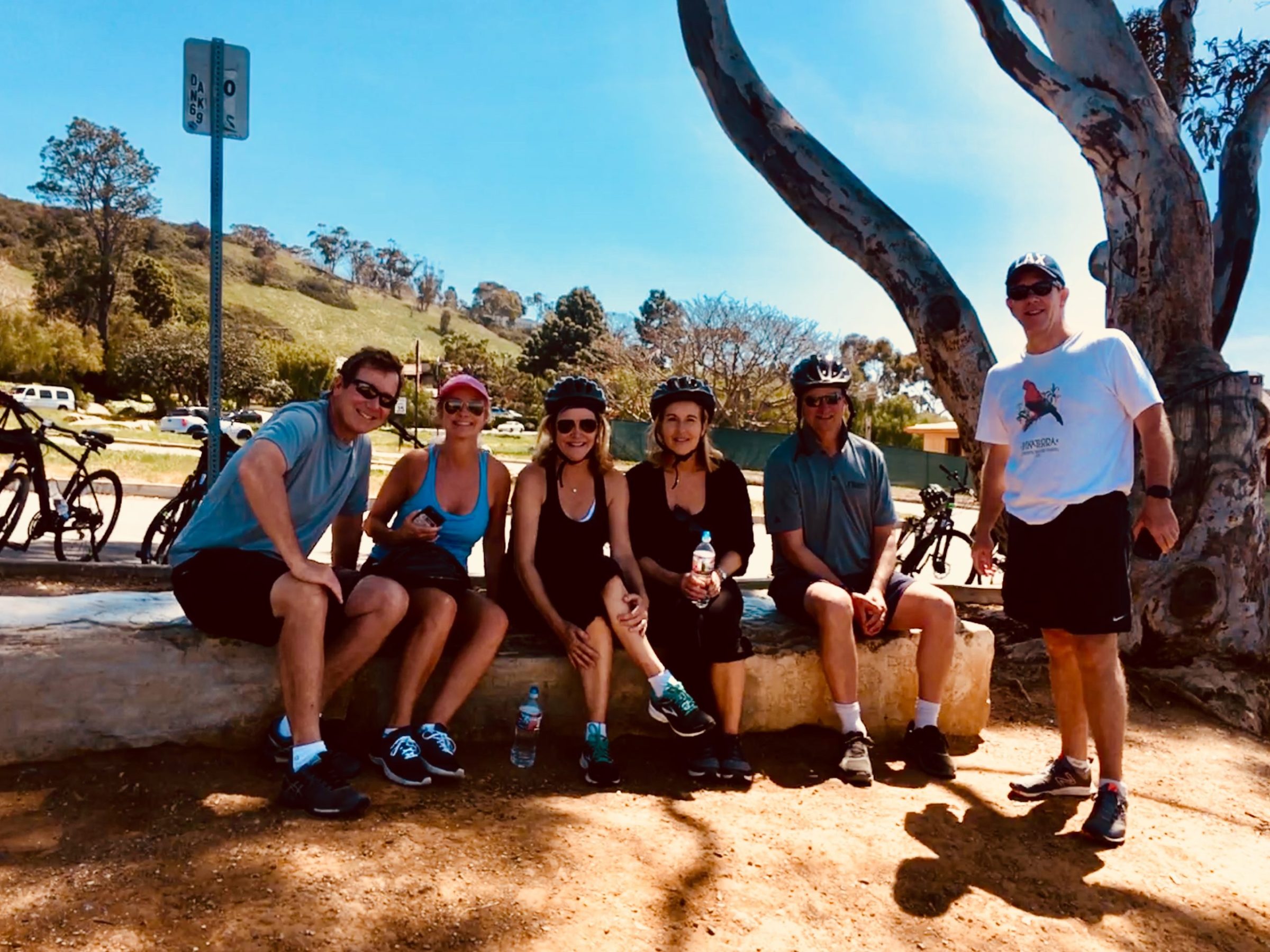 a group of people on a beach posing for the camera