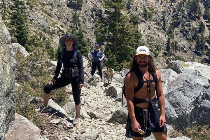a group of people standing on a rocky hill
