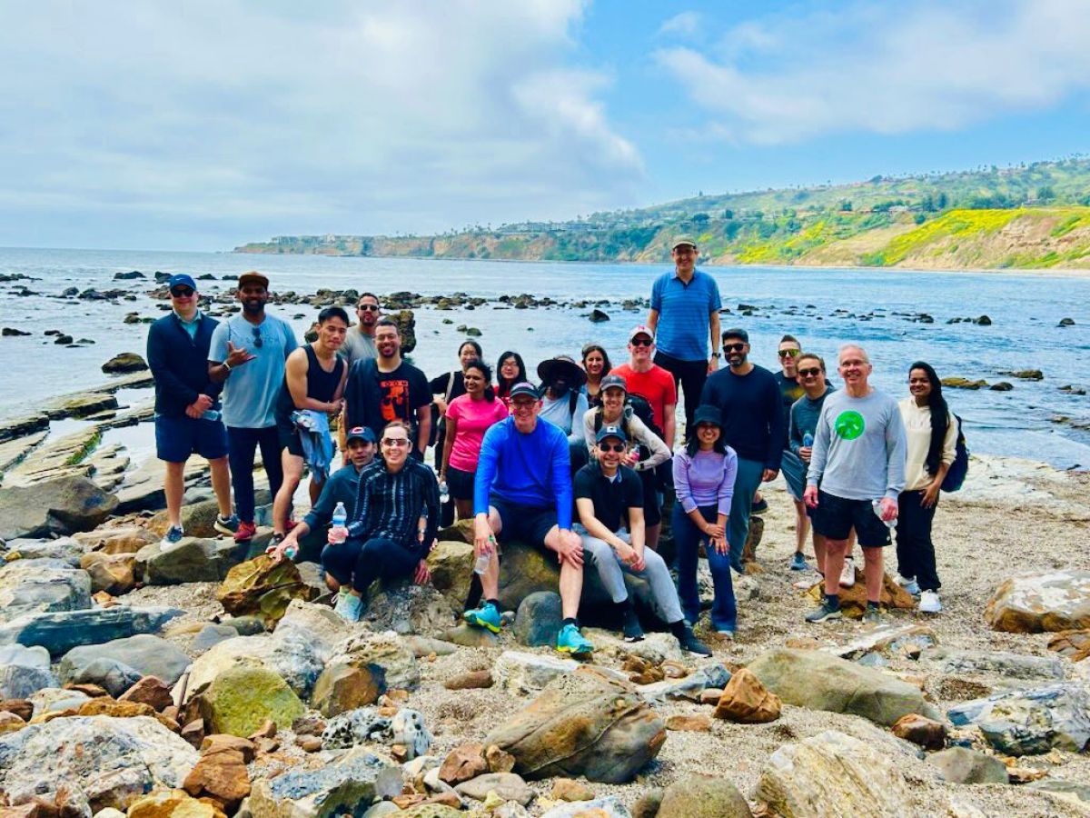 a group of people standing on a rocky beach