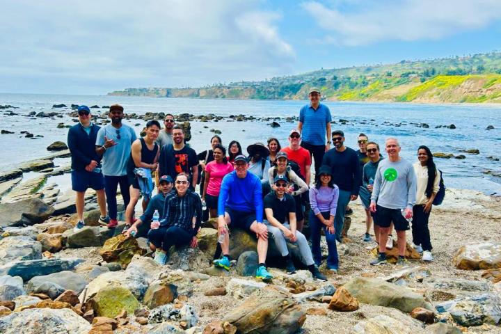 a group of people standing on a rocky beach on a terranea group tour