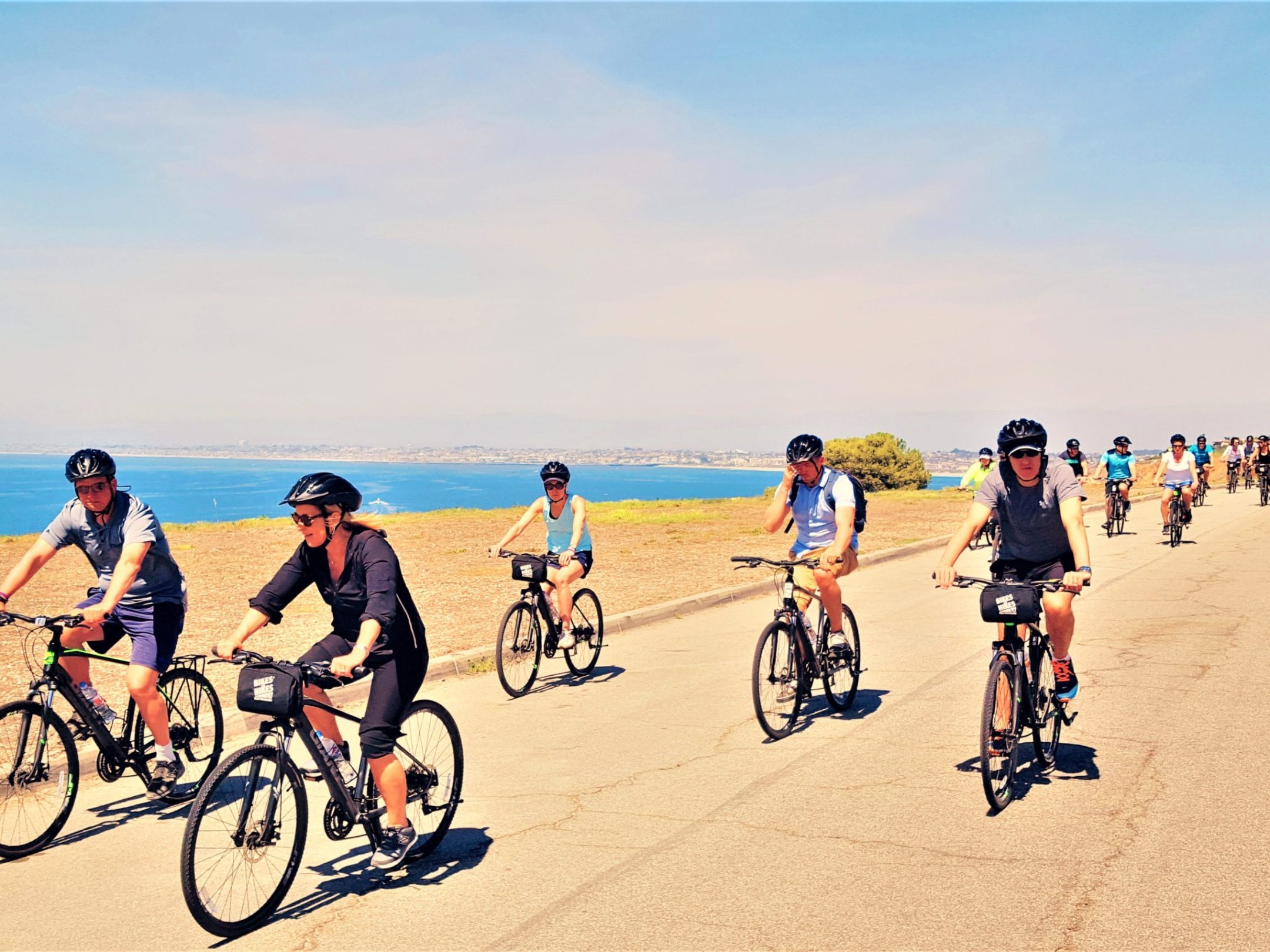 a group of people riding on the back of a bicycle