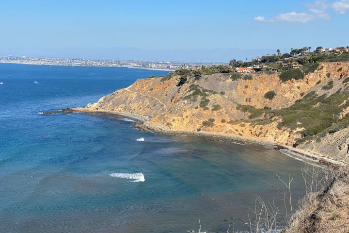 a rocky beach next to a body of water