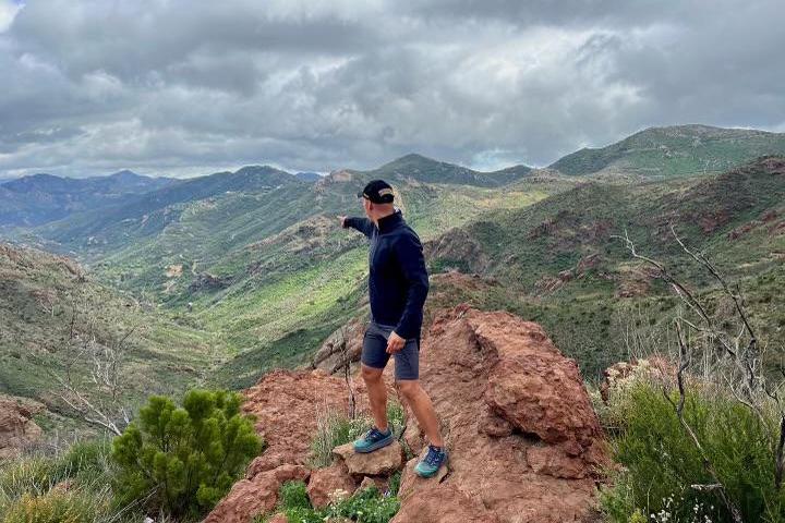 a man standing in front of a mountain