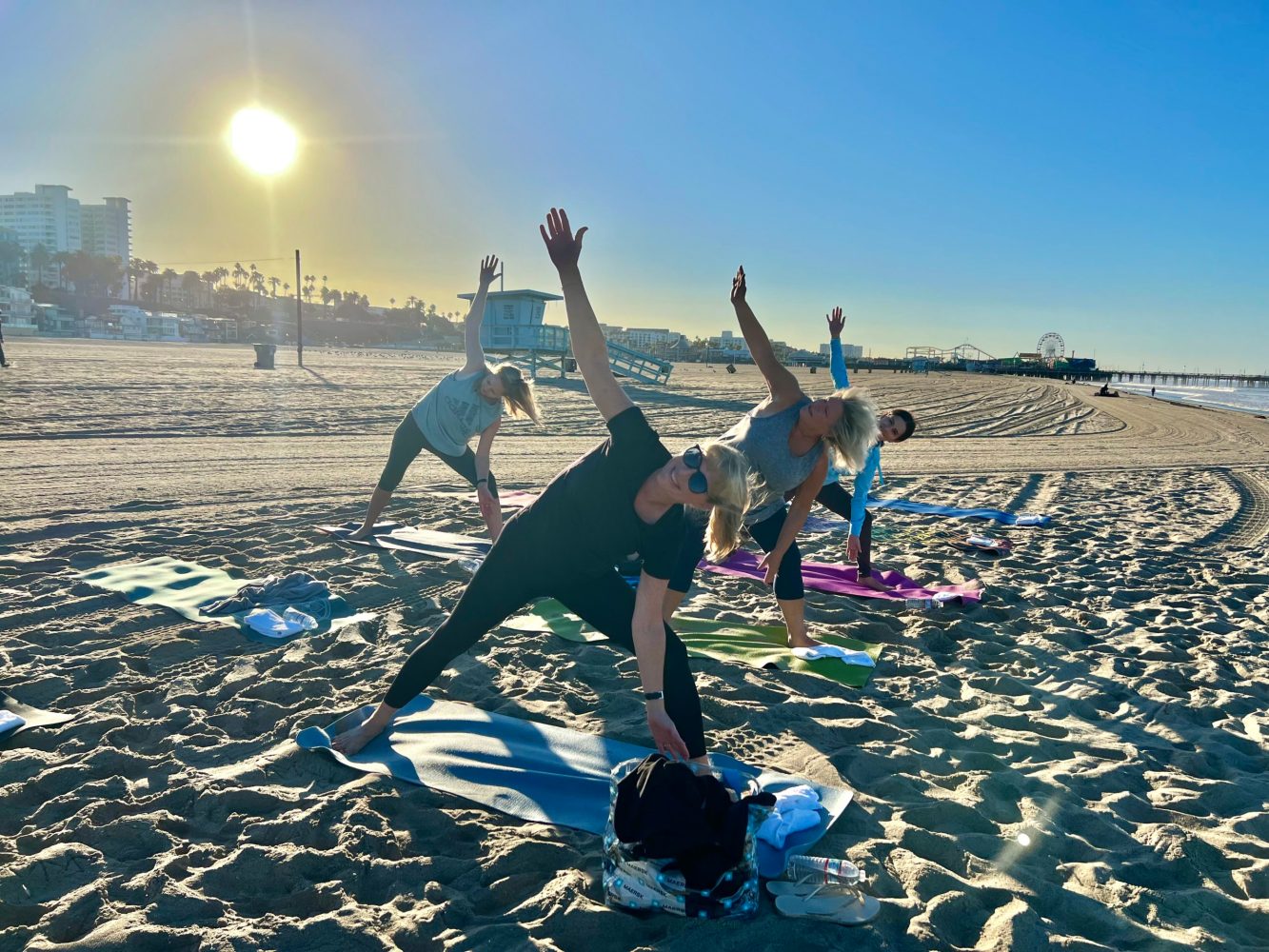 a group of people doing yoga at an outdoor team building event