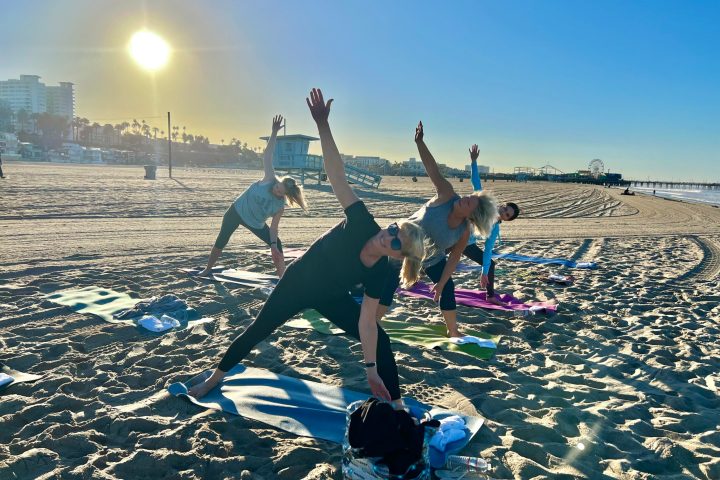 a group of people doing yoga at an outdoor team building event