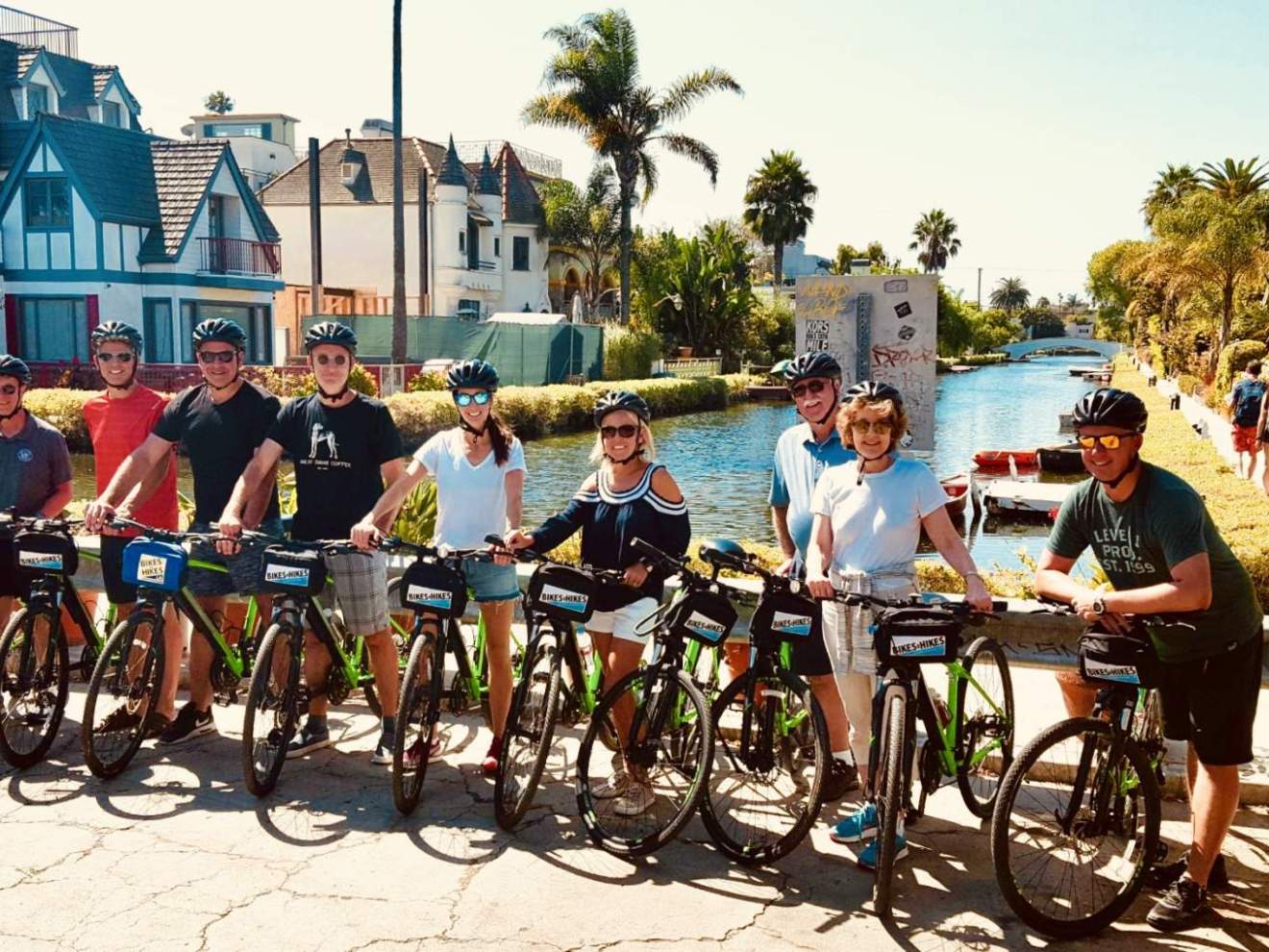 a group of people with bicycles at the venice canals