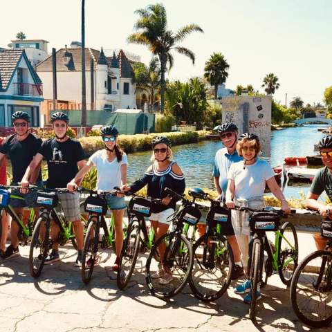 a group of people with bicycles at the venice canals