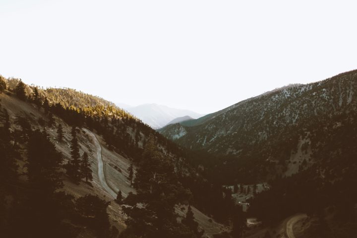 a man riding a snowboard down a snow covered mountain