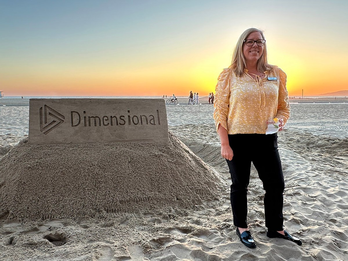 a woman standing next to a body of water