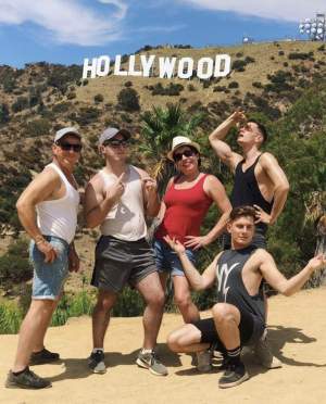 group posing in front of Hollywood sign