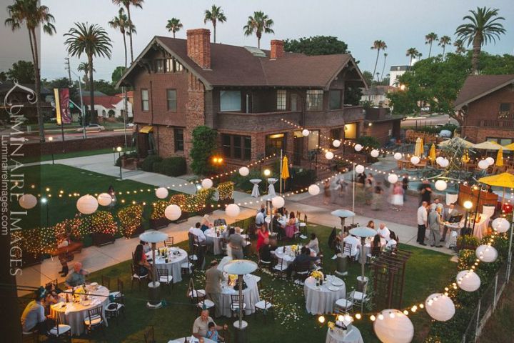 a group of people sitting at a table in front of a building