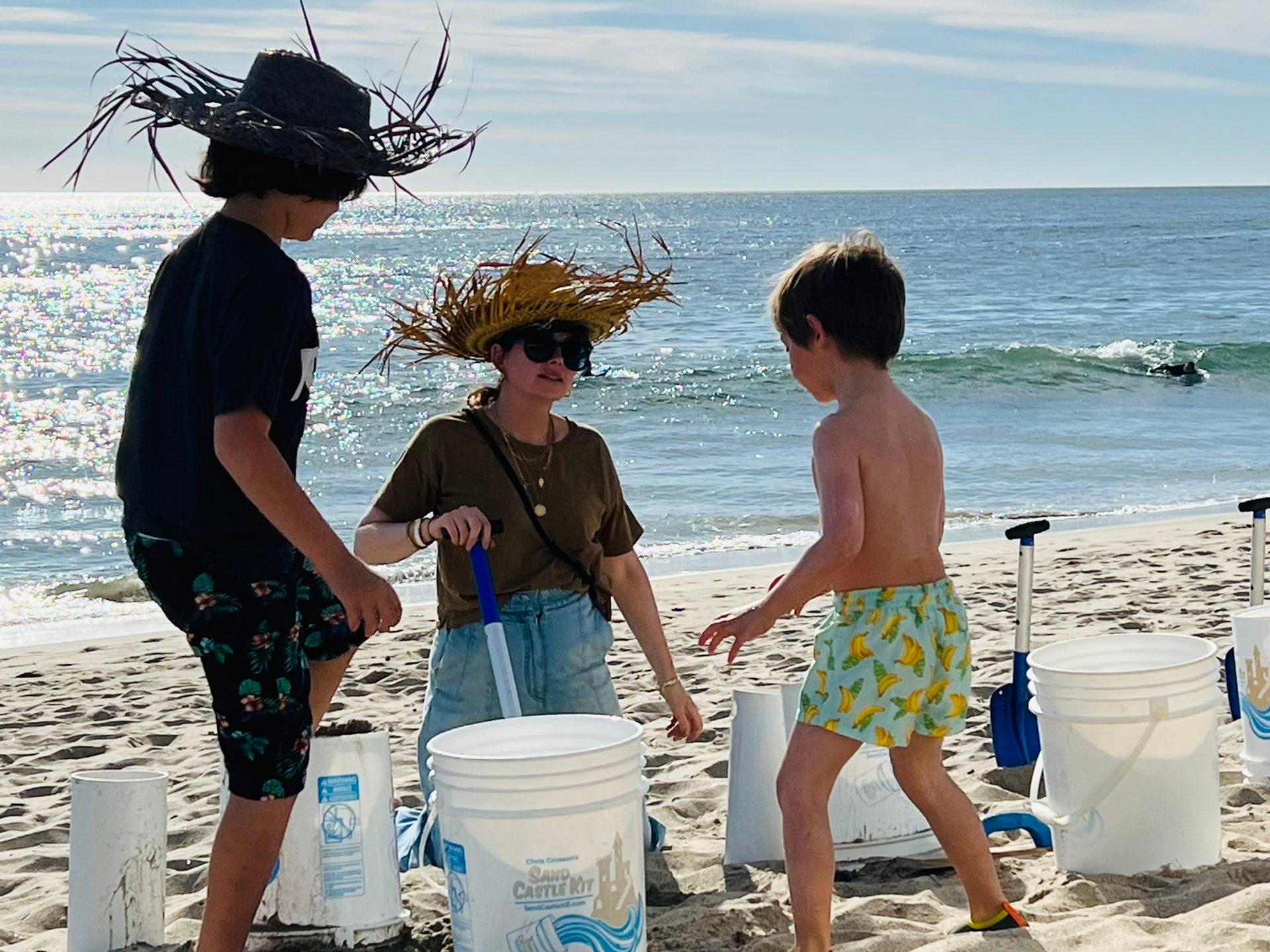 a couple of people that are standing in the sand on a beach