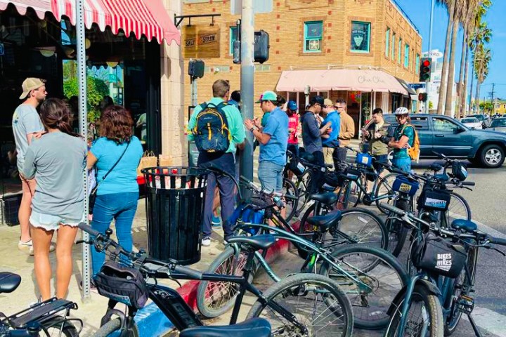 a group of people standing on the venice boardwalk on a los angeles tour