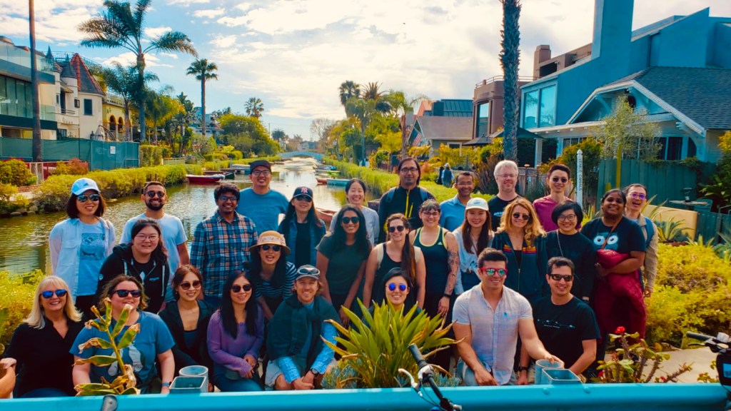 a group of people posing for a photo on a tour of the venice canals los angeles