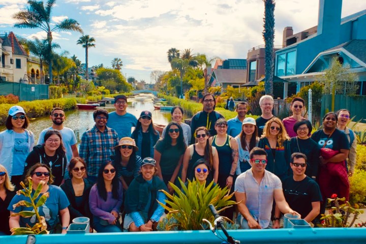 a group of people posing for a photo on a tour of the venice canals los angeles