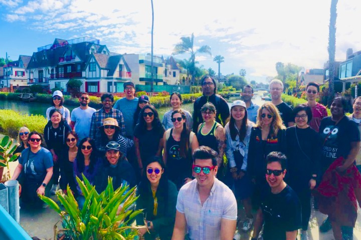 a group of people posing for a photo on a los angeles city tour in venice ca