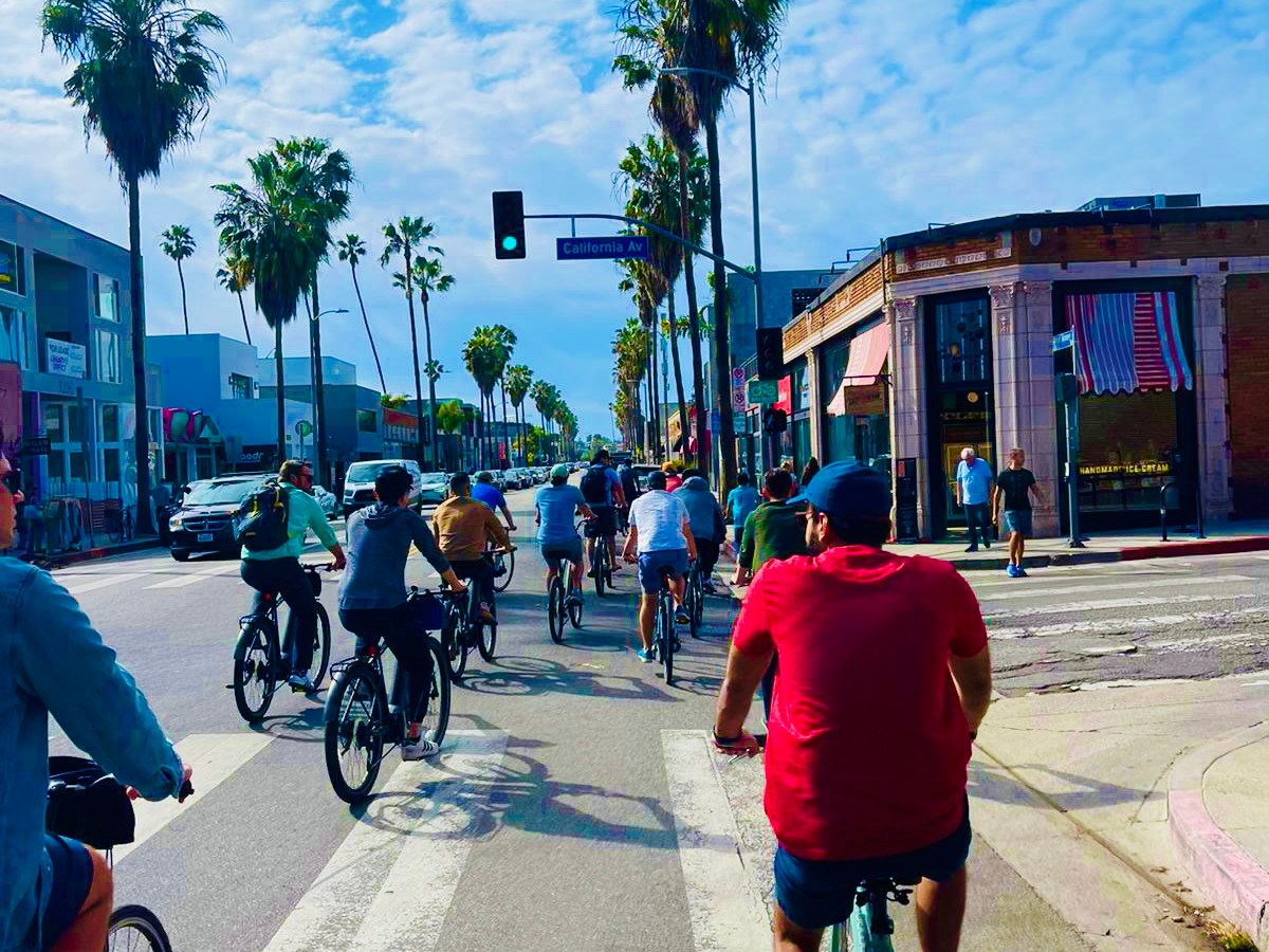 a group of people riding bikes in venice, california on an la city tour