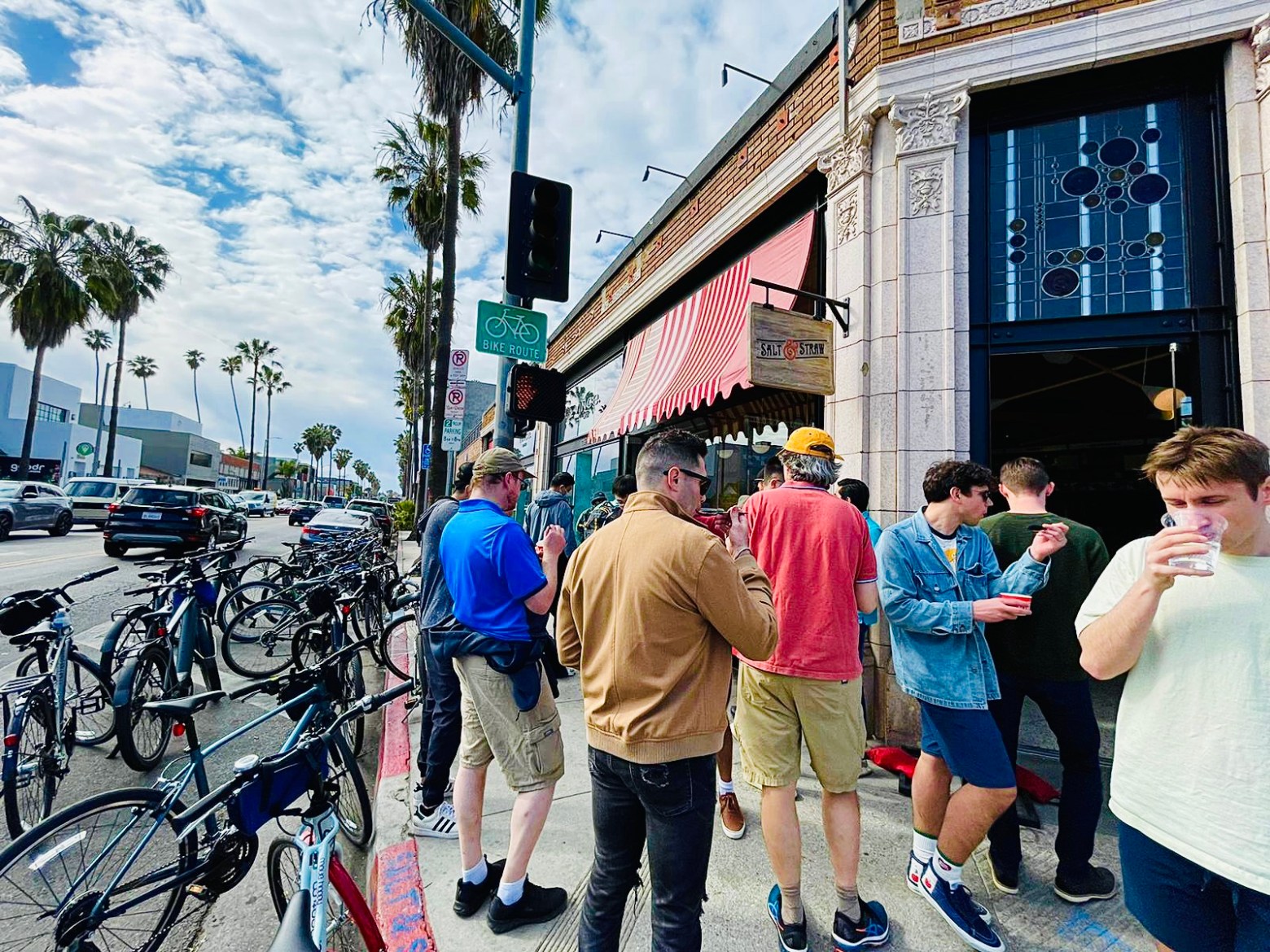 a group of people walking down the street on an la bike tour in venice ca
