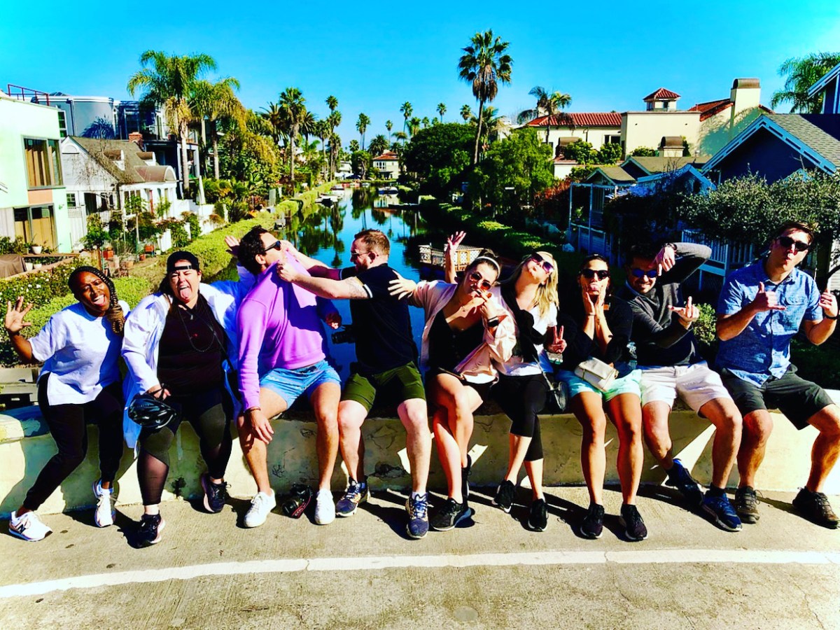 a group of people walking in the venice canals