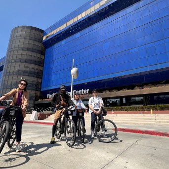 a group of people riding on the back of a bicycle