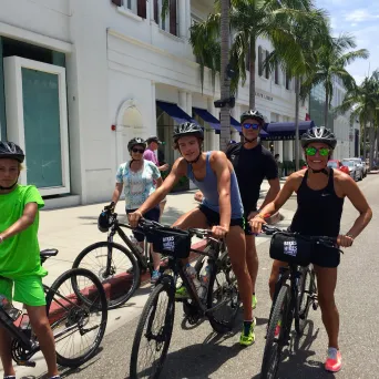 a group of people riding on the back of a bicycle