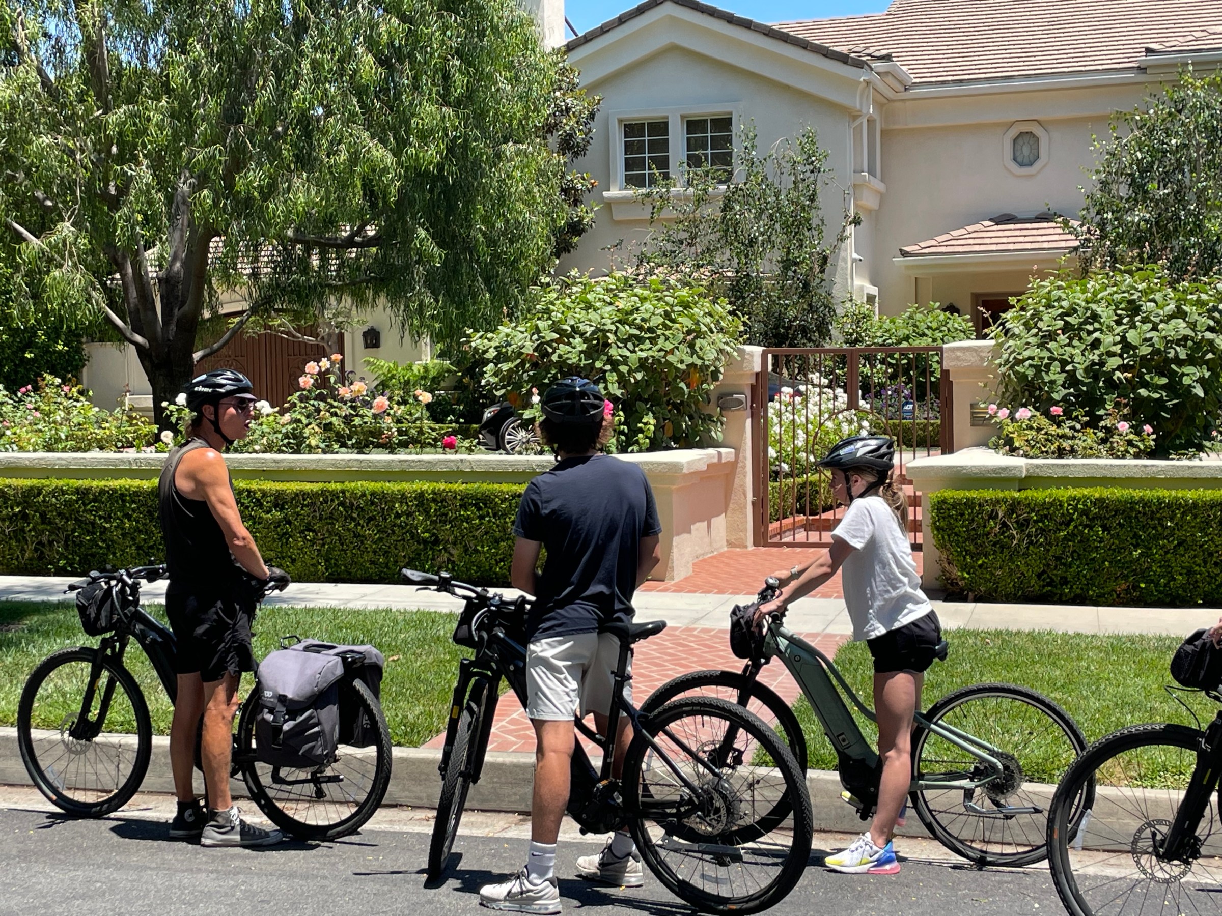 a group of people riding on the back of a bicycle