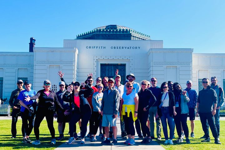 a group of people standing in front of the griffith observatory