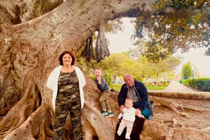 a couple of people that are sitting on a rock