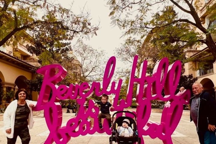 a group of people sitting on a bench posing for the camera