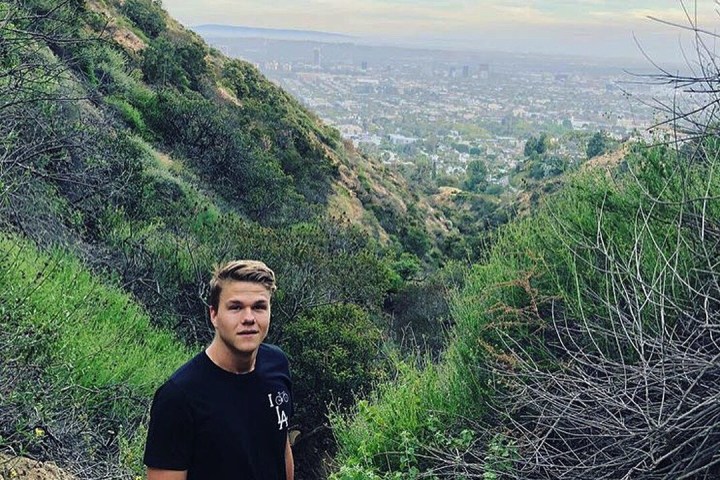 A hiker poses for a picture on the Runyon Canyon Trail in West Hollywood, California