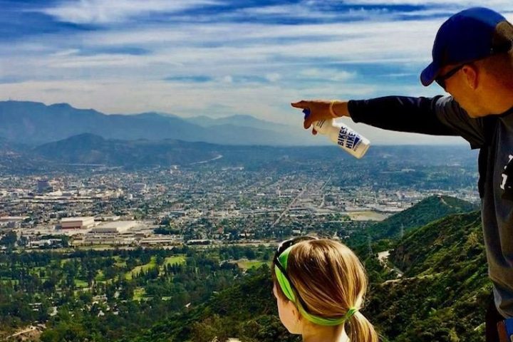 a man standing next to a little girl on a mountain