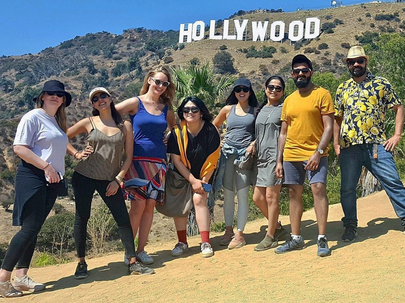 group of hikers underneath the hollywood sign on the hollywood sign walking tour