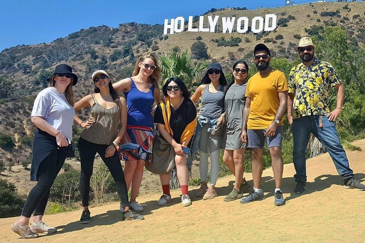 group of hikers underneath the hollywood sign on the hollywood sign walking tour