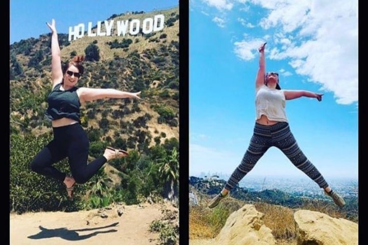 two girls jump in the air in front of hollywood sign