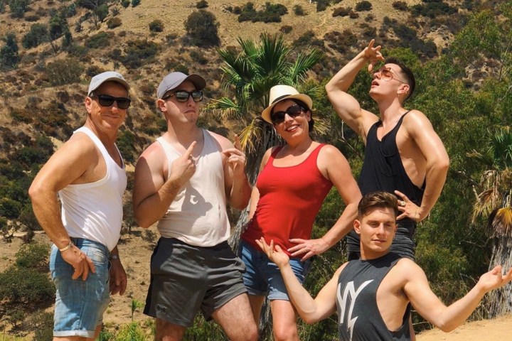 five people in front of hollywood sign