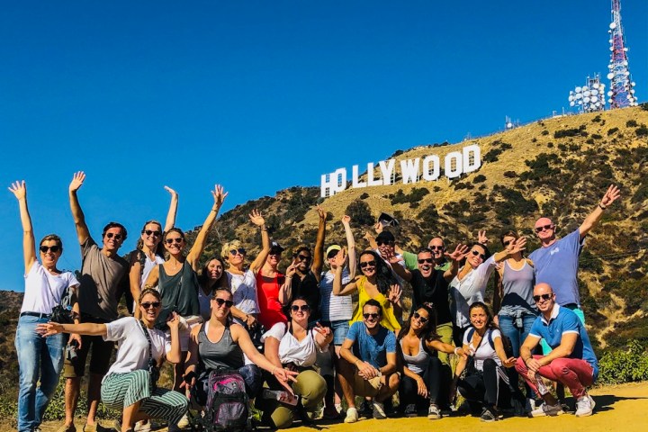 a group of people standing in front of a crowd posing for the camera