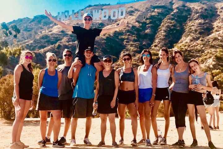 group of hikers below the hollywood sign on a hollywood sign tour