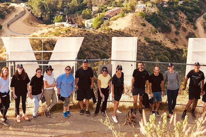 group of hikers behind the hollywood sign on a hollywood hills hike