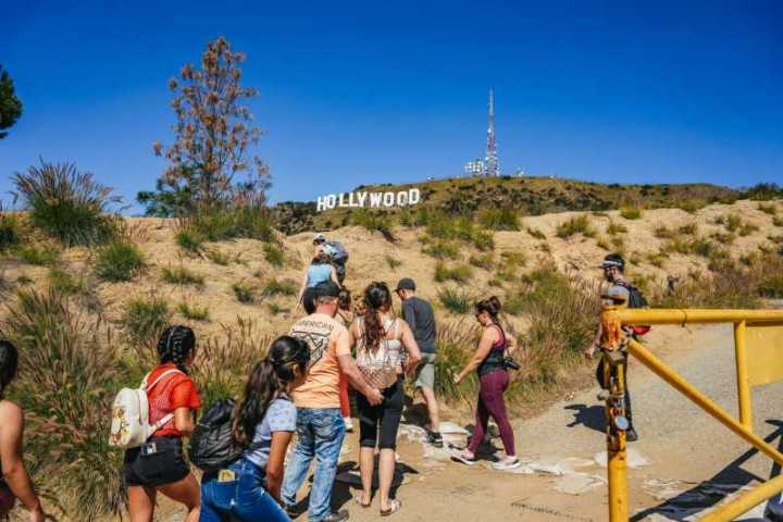 a group of people walking on a beach