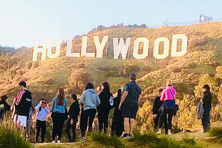 a group of people standing in front of a crowd posing for the camera