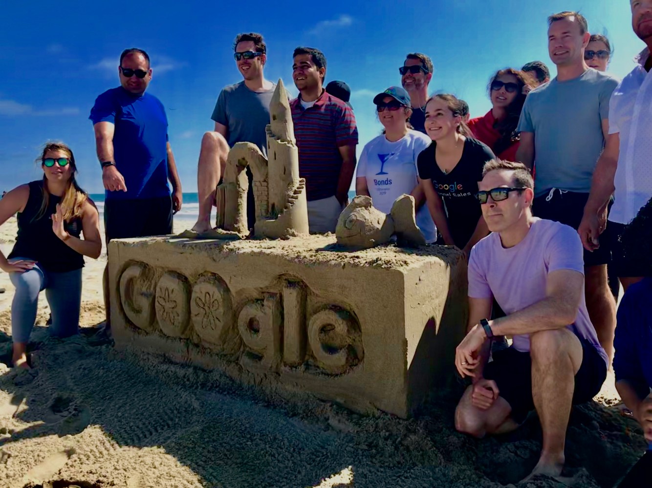 Group of people doing a group sandcastle building lesson