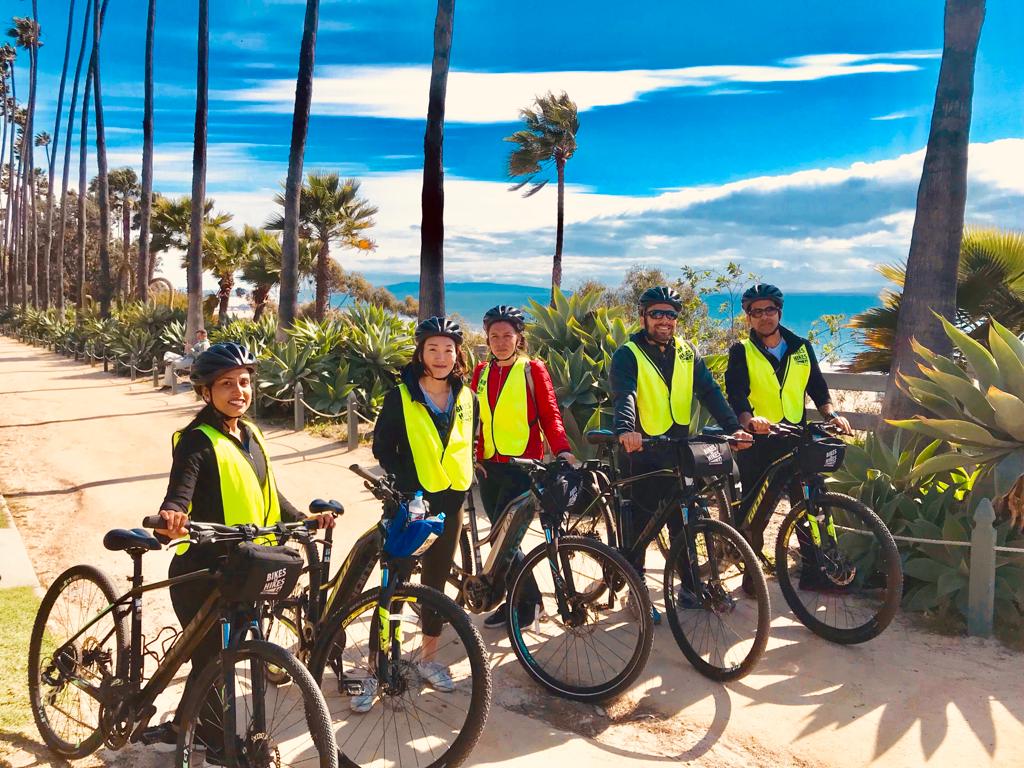 a group of people riding on the back of a bicycle