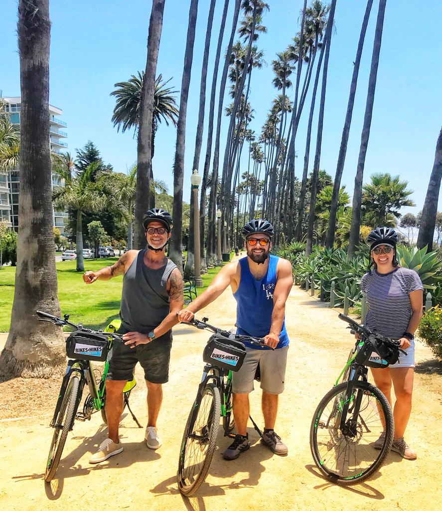 a group of people riding on the back of a bicycle